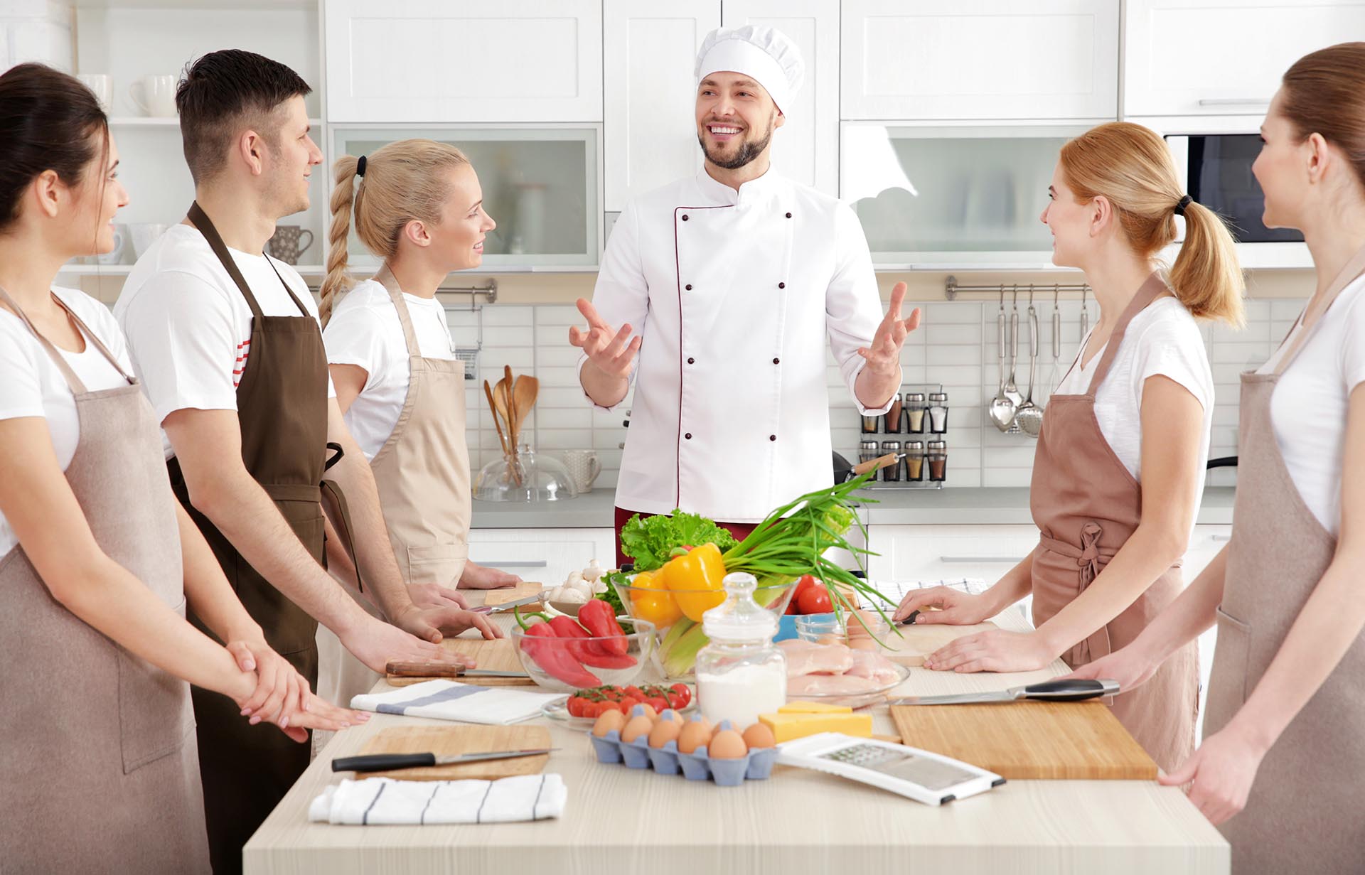 Warm and inviting culinary studio with organized preparation stations and a welcoming atmosphere for cooking classes